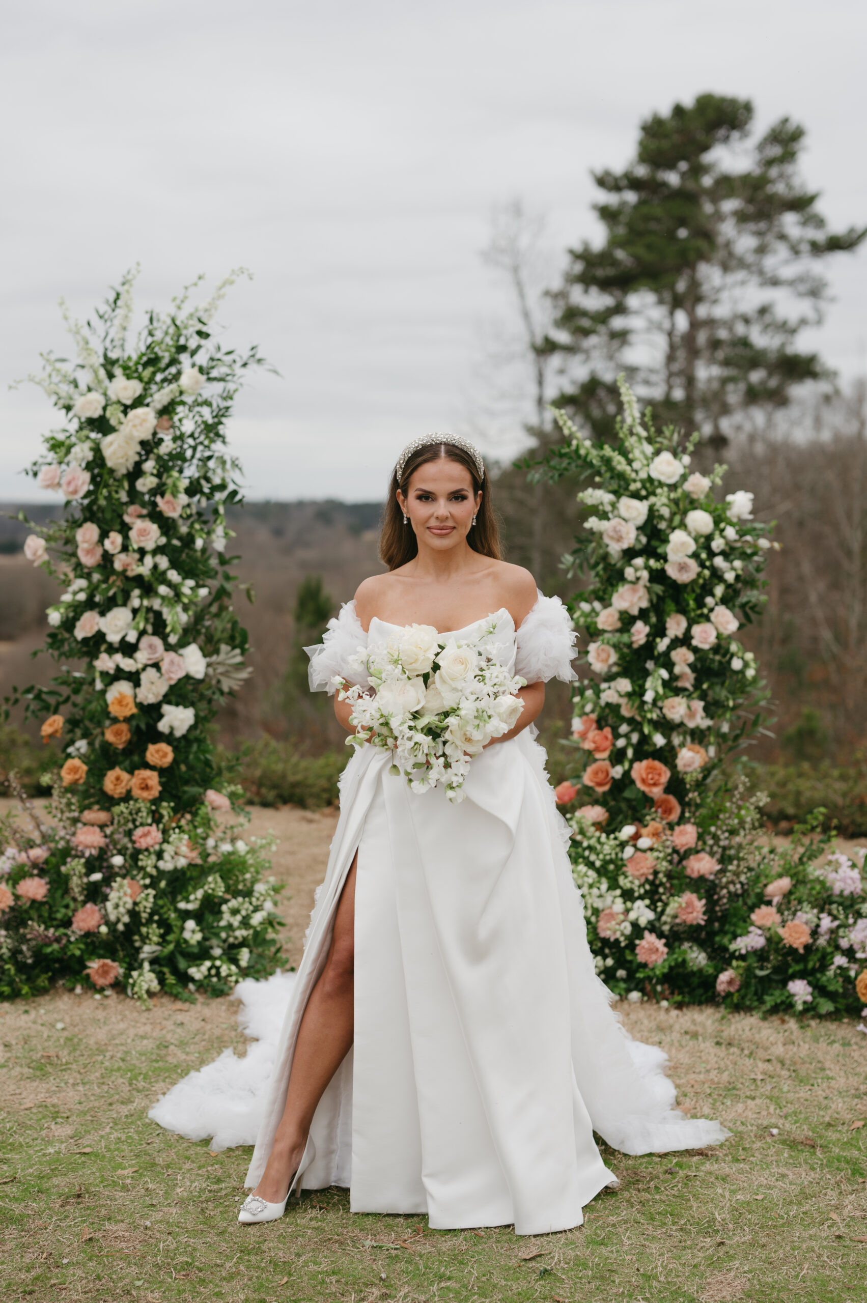 Chantelle, this gorgeous bride, wore a modern wedding dress and a secondhand bridal cape at her colorful luxury wedding at Foxhall Resort with a broken floral arch. | Megan Kuhn Photography