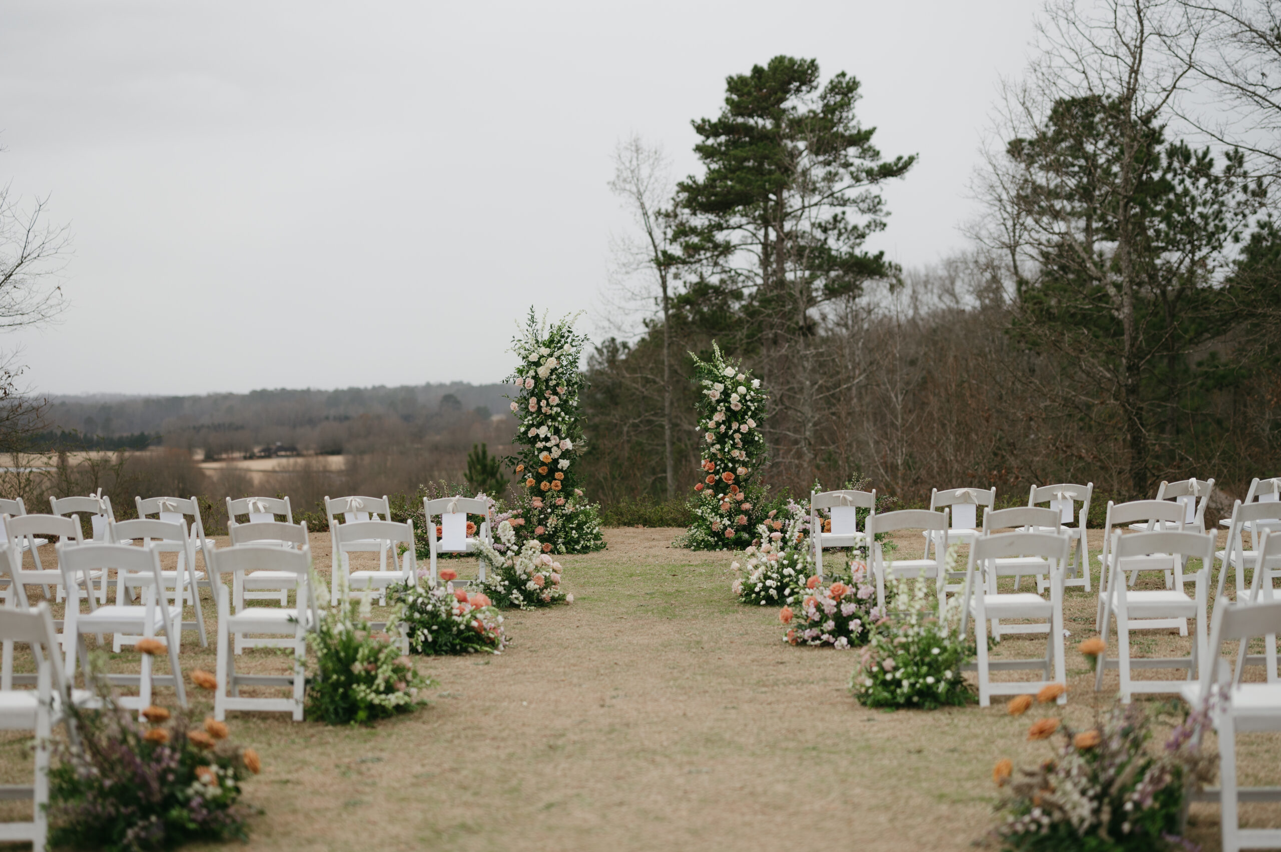 This colorful luxury wedding at Foxhall Resort had a broken floral arch and an aisle full of flowers. | Megan Kuhn Photography