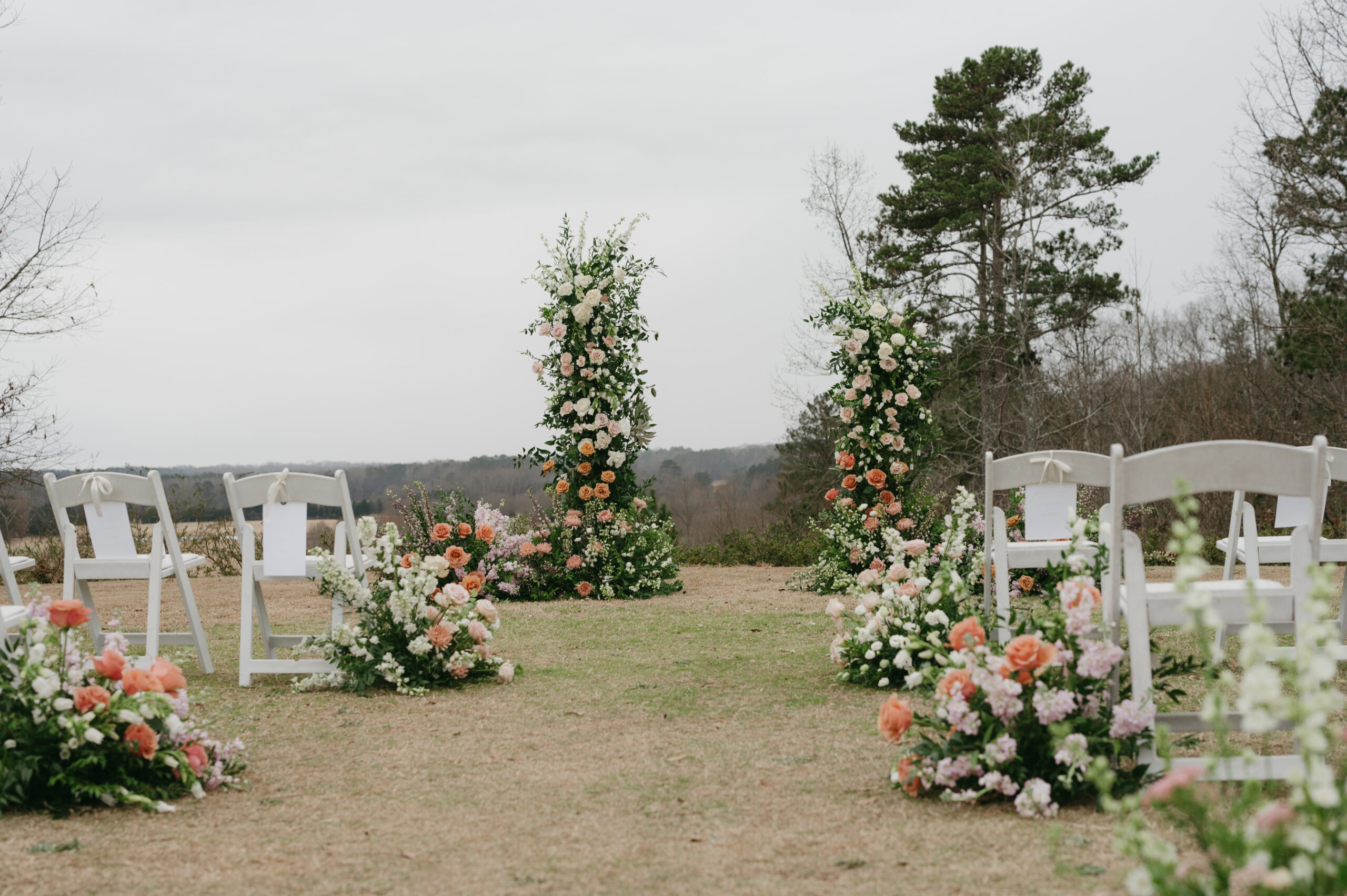 This colorful luxury wedding at Foxhall Resort had a broken floral arch and an aisle full of flowers. | Megan Kuhn Photography