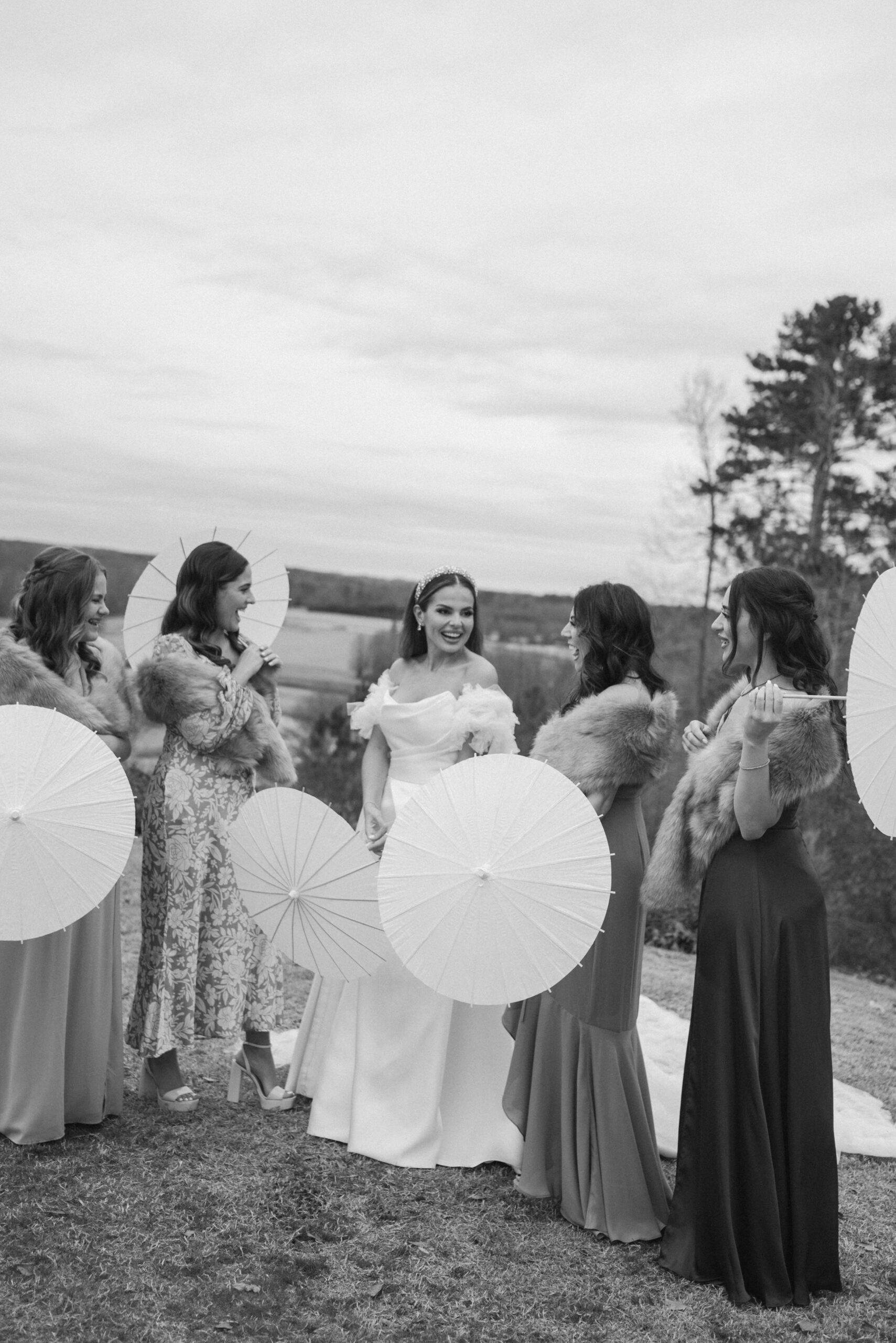 These bridesmaid parasols were so modern and brought a garden party feel to a cold December wedding at Foxhall Resort. | Megan Kuhn Photography