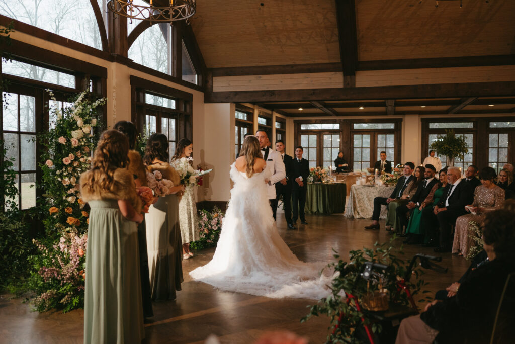 Luxury wedding at Foxhall Resort with a broken floral arch and candles. | Megan Kuhn Photography